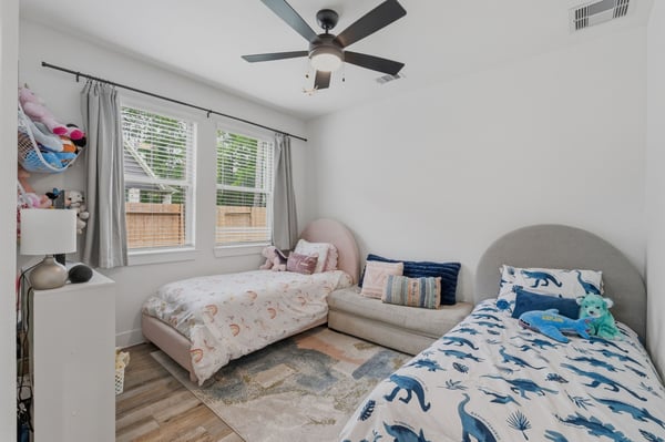 French doors lead into this home office space that is currently being used as a 5th bedroom for little ones.