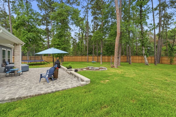 The backyard is massive! Fire pit, mature trees, and plenty of space to play.