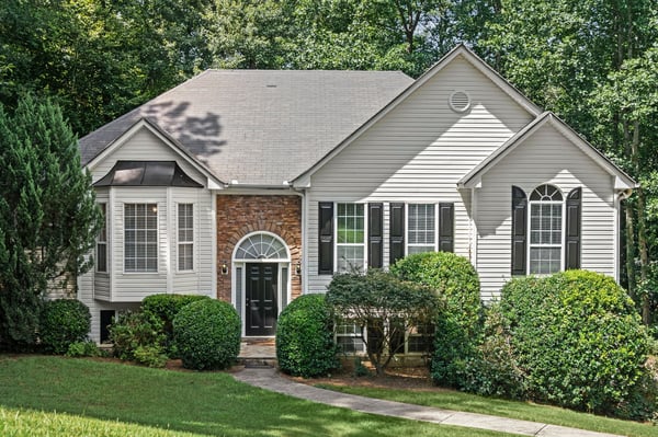 Discover this inviting two-story home, featuring a welcoming entrance and a beautifully landscaped front yard.