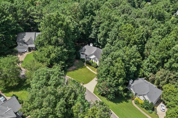 Nestled among mature trees, this inviting home offers a private retreat with spacious outdoor areas.