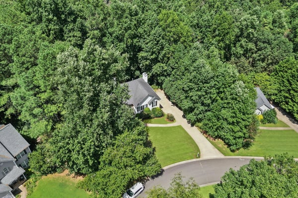 Nestled among lush foliage, this home offers privacy while remaining conveniently close to community amenities.