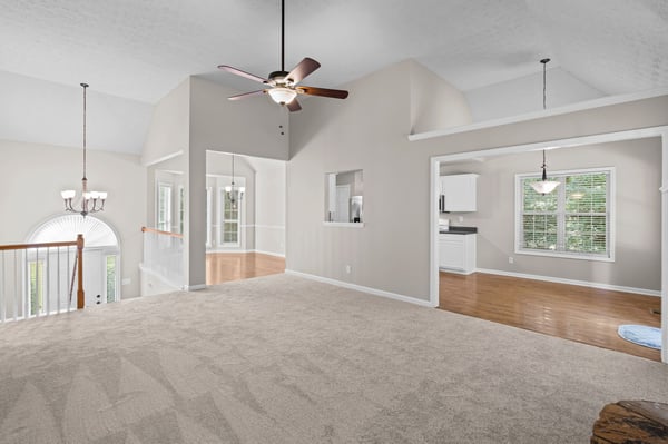 Spacious open layout with high ceilings, abundant natural light, and easy access to the kitchen.