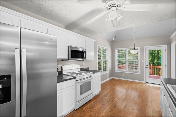 Bright kitchen featuring modern appliances, ample natural light, and easy access to outdoor space.