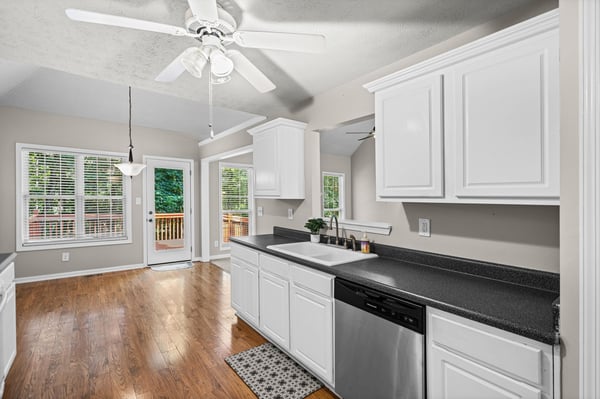 Bright kitchen featuring modern appliances, ample cabinetry, and natural light flowing through spacious windows.
