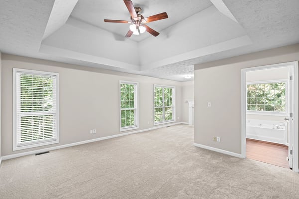 Spacious room with high ceilings and abundant natural light, perfect for creating your ideal living space.