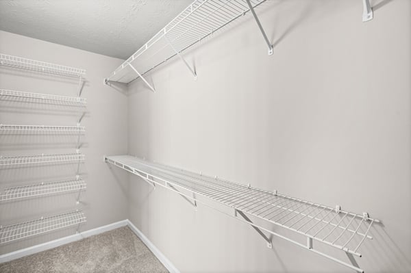 Spacious closet featuring organized shelving, perfect for maximizing storage and keeping belongings easily accessible.