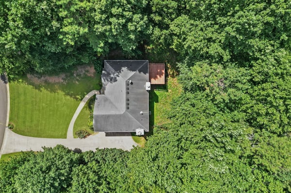 Discover this private retreat nestled among lush trees, featuring a spacious yard and easy access to nearby roads.