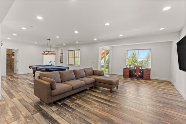Spacious open-concept living area featuring a billiards table and a large window with stunning views.