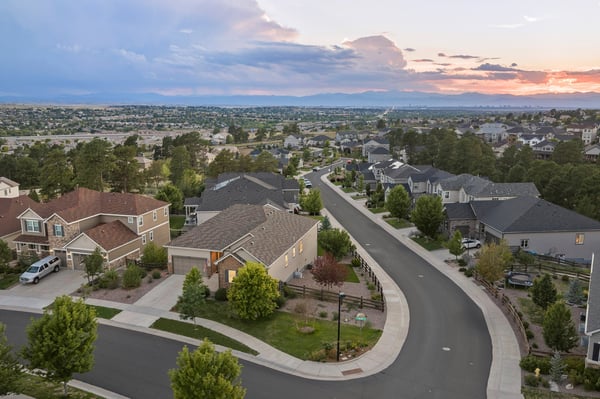 Discover a peaceful neighborhood with spacious homes and stunning sunset views on a scenic, winding street.