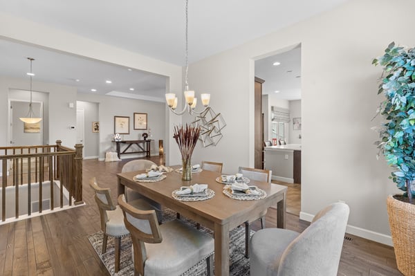 Bright dining area with modern lighting and an open layout, perfect for entertaining guests.