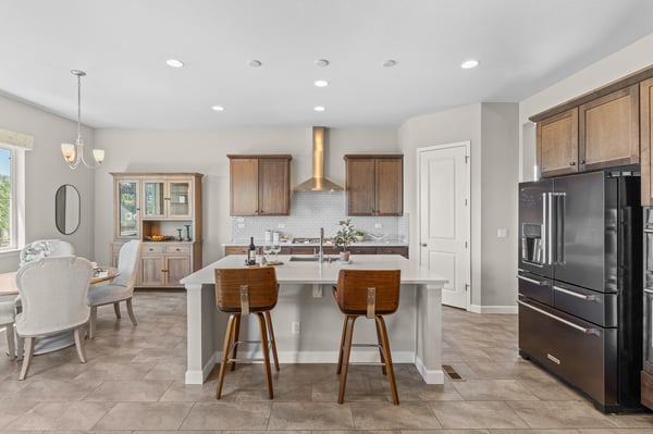 Bright and functional kitchen featuring an island, modern appliances, and ample dining space for family gatherings.