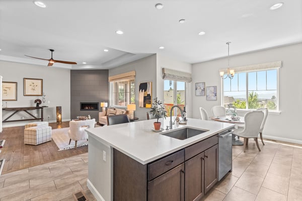 Bright and airy open-concept living area seamlessly connects the kitchen, dining, and lounge spaces with scenic views.