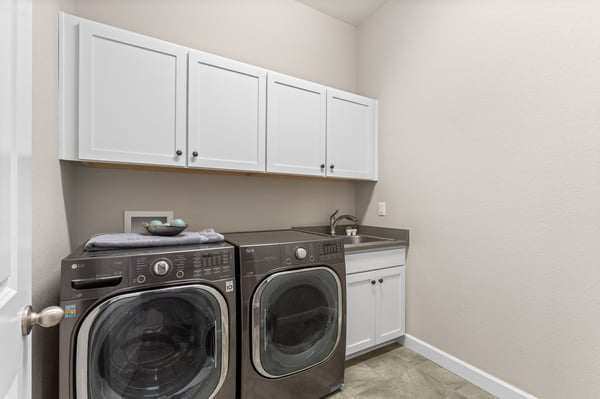 Bright and functional laundry room featuring modern appliances and ample storage for convenience and organization.
