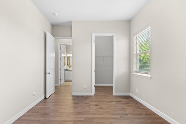 Bright and airy room featuring hardwood floors, natural light, and a spacious closet, perfect for personalization.