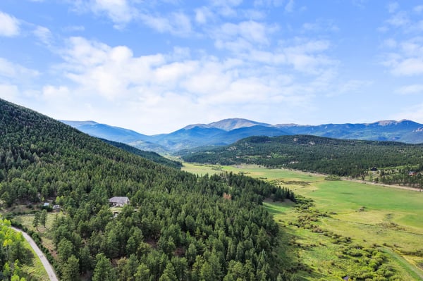 Discover a stunning, expansive landscape surrounded by mountains and lush forests, perfect for private retreat living.
