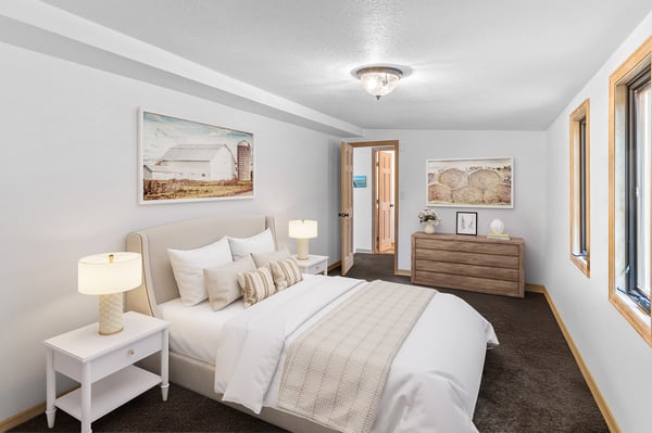 Bright and inviting bedroom features modern decor, ample natural light, and a cozy atmosphere for relaxation.