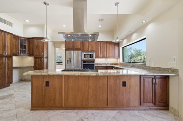 Spacious kitchen with modern appliances and a large island, perfect for gatherings and culinary adventures.