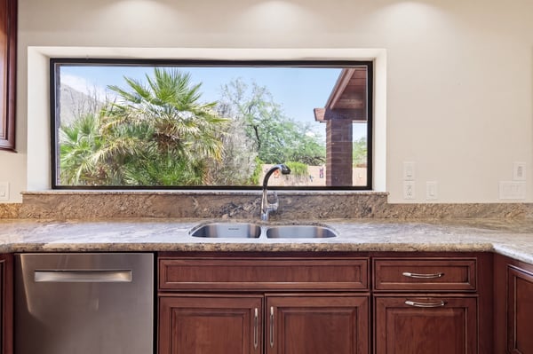 Bright kitchen featuring a large window that frames stunning outdoor views and natural light.
