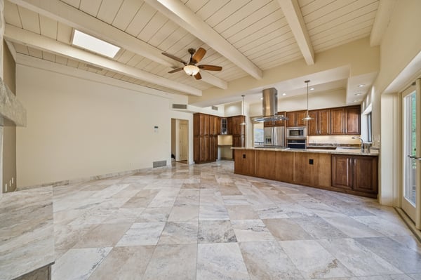Spacious open-concept kitchen and living area featuring natural light, modern appliances, and ample cabinetry.