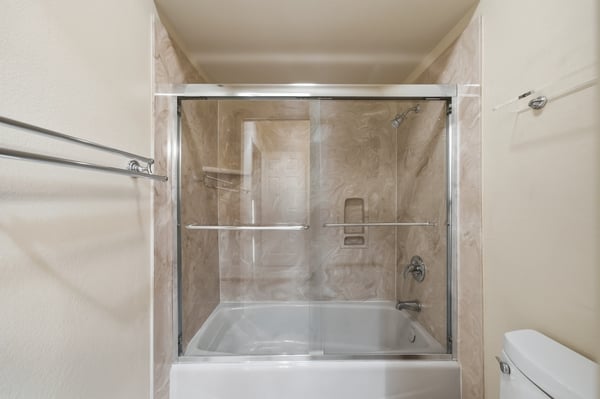 Modern bathroom featuring a sleek glass shower enclosure and spacious soaking tub for ultimate relaxation.