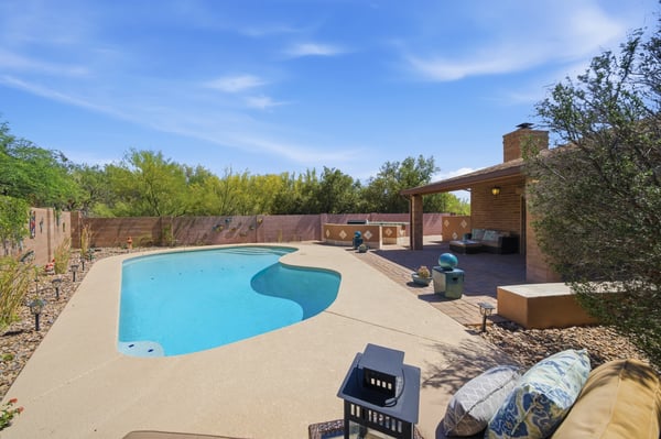 Discover this inviting backyard oasis featuring a refreshing pool and ample space for outdoor gatherings.