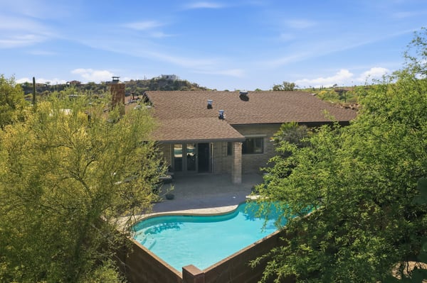 Discover this inviting home with a private pool, nestled among lush landscaping and scenic views.