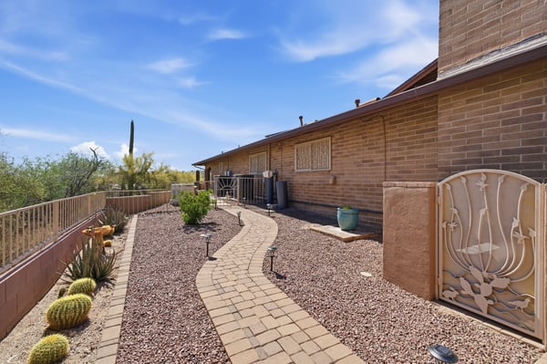 Explore this inviting desert landscaping with a meandering pathway, perfect for outdoor enjoyment and low maintenance.