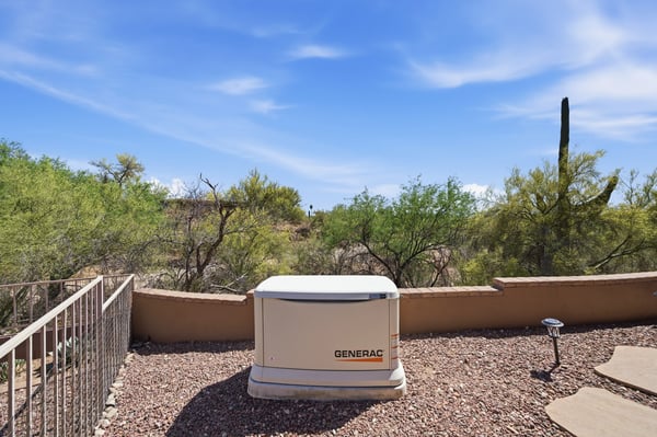 Discover a unique outdoor space featuring a Generac generator and stunning desert landscape views.