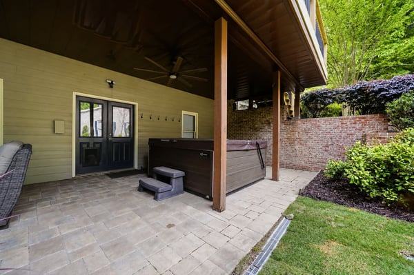 Discover this covered patio featuring a hot tub, perfect for outdoor relaxation and entertaining.