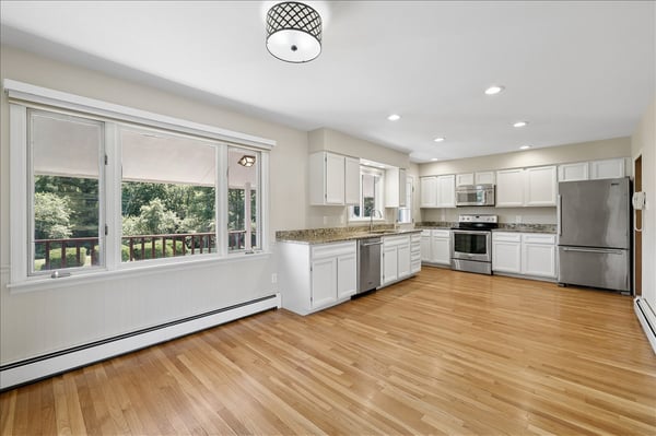 Spacious kitchen with modern appliances and ample natural light, perfect for culinary enthusiasts and gatherings.