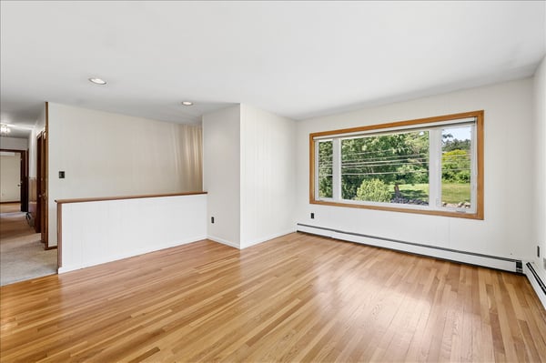 Bright and open living space featuring large windows and versatile layout, ideal for various design options.