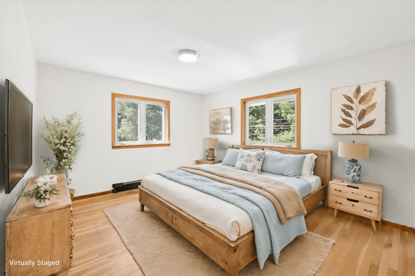 Bright and inviting bedroom featuring large windows, natural wood accents, and modern furnishings for comfort.
