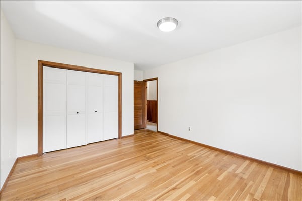 Spacious room featuring hardwood floors and ample natural light, perfect for customization or relaxation.