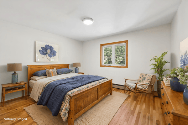 Bright and airy bedroom featuring warm wood accents, natural light, and inviting decor for ultimate comfort.