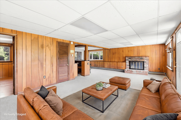 Spacious living area featuring large windows and a cozy fireplace, perfect for family gatherings and relaxation.