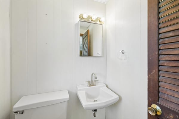 Modern half-bath featuring sleek fixtures and clean lines, perfect for maximizing space and functionality.