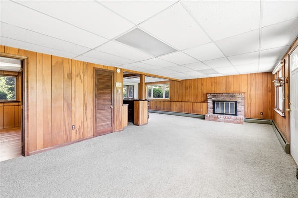 Spacious living area with natural light and cozy fireplace, perfect for creating your ideal retreat.