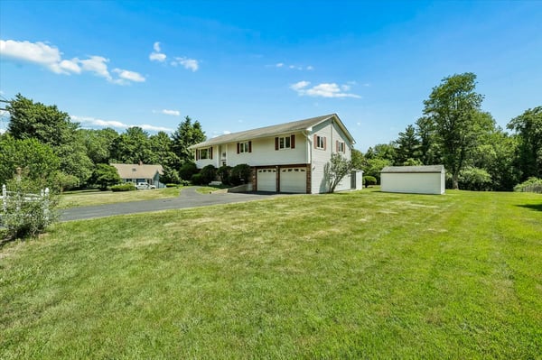 This spacious home features a large yard, ample parking, and scenic views in a quiet neighborhood.