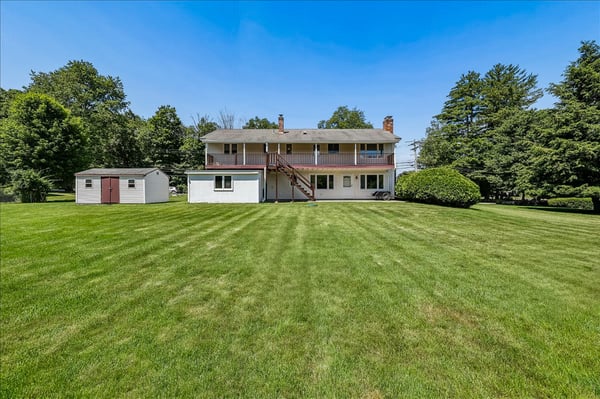 Inviting multi-level home with spacious backyard and convenient shed, perfect for outdoor activities and storage.