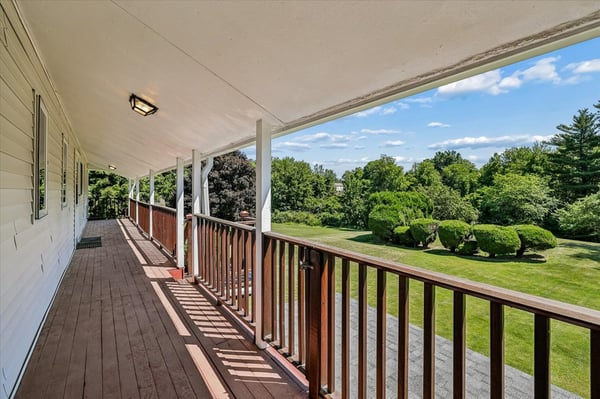 Enjoy expansive outdoor views from this spacious covered balcony, perfect for relaxing or entertaining.