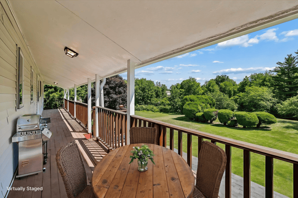 Spacious outdoor deck offers scenic views, perfect for relaxing or entertaining in a tranquil setting.
