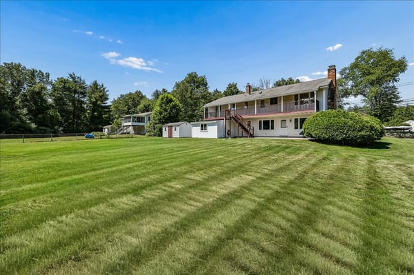 Spacious property featuring a large backyard and a multi-level home, perfect for outdoor gatherings and relaxation.