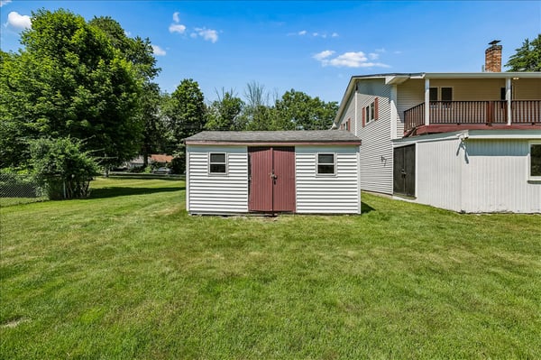 Spacious backyard featuring a practical storage shed, perfect for keeping tools and outdoor equipment organized.