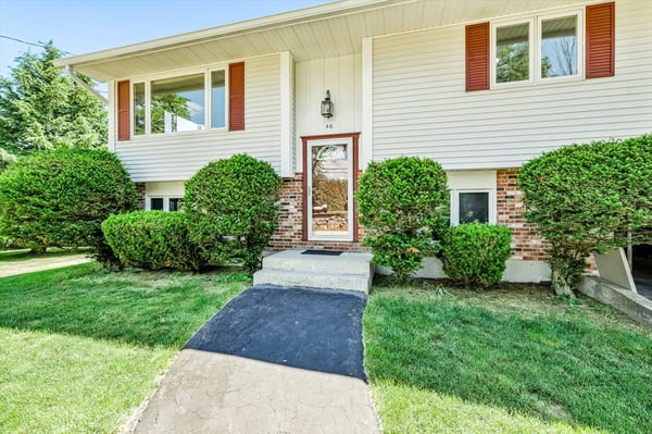 This well-maintained split-level home features inviting landscaping and a welcoming entrance. Perfect for family living.