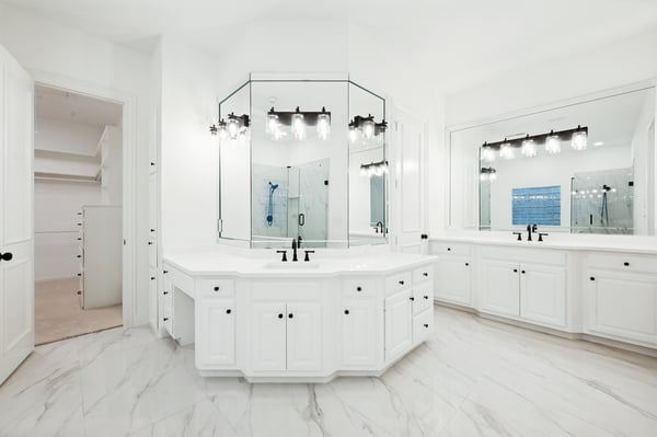 Spacious primary bathroom featuring dual vanities, modern fixtures, and abundant natural light for a refreshing retreat.
