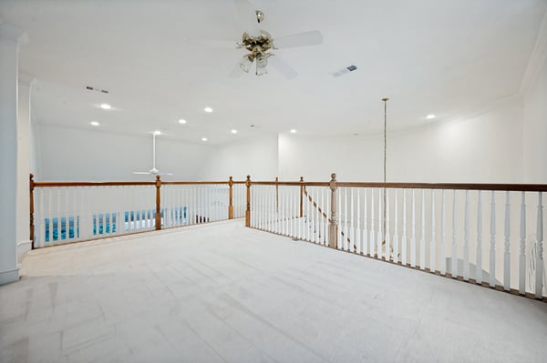 Spacious second-floor landing offers ample light and a view overlooking the inviting indoor swimming pool area.