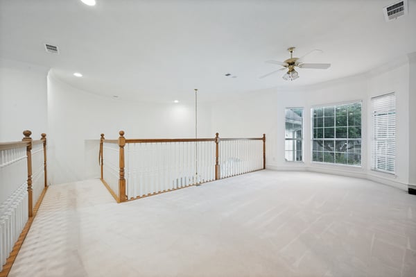 Spacious open area featuring unique architecture and ample natural light, perfect for versatile living options.