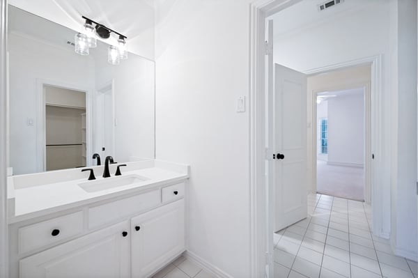 Bright and inviting bathroom featuring modern fixtures and a spacious layout, perfect for everyday comfort.