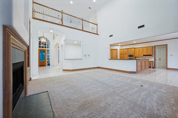 Spacious open-concept living area features high ceilings, ample natural light, and a seamless flow to the kitchen.