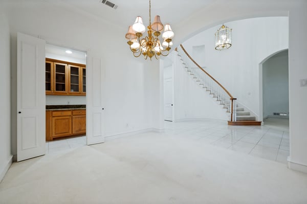 Spacious entryway featuring bright open areas, a graceful staircase, and quality finishes throughout the home.